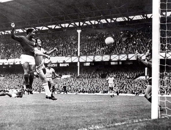 World Cup Finals, 1966. Liverpool, England. 19th July, 1966. Portugal 3 v Brazil 1. Eusebio of Portugal (L) beats Brazil's Orlando to the ball to head home his side's second goal past Brazilian goalkeeper Manga during their Group Three match